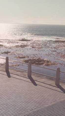 light spot against aerial view of african american fit woman running on the promenade