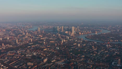 high altitude drone shot of canary wharf and tower hamlets at sunset