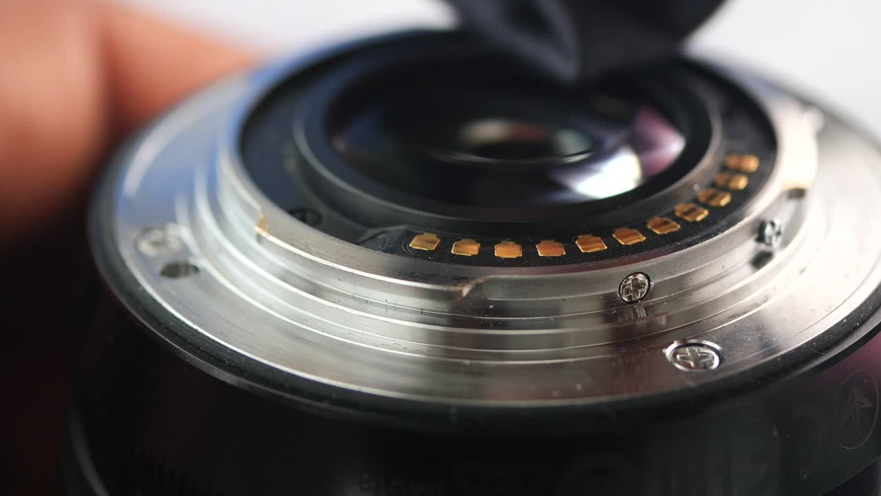Close-up of a camera lens being cleaned