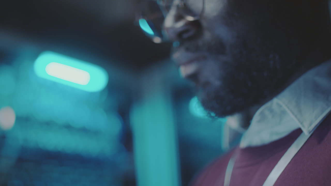 Close-up of a Man with Glasses and Beard in Blue Light