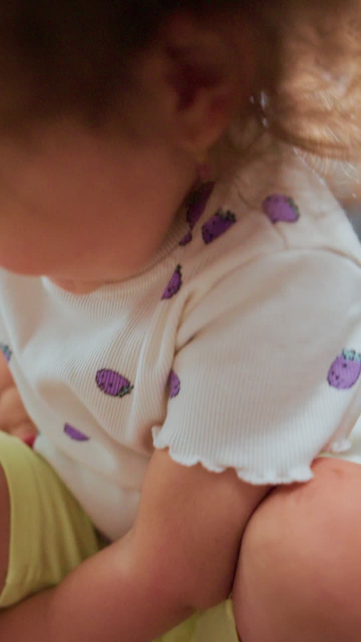 A Joyful Moment Captured: A Young Child Playing and Smiling Enthusiastically in a Bright and Cheerful Indoor Setting
