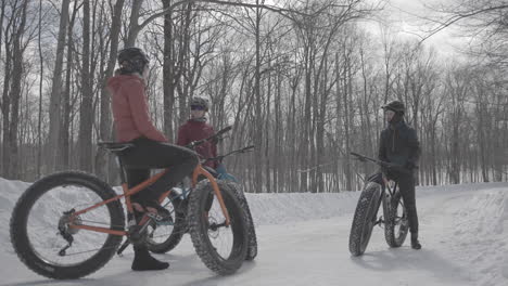 group of riders fat biking in the forest