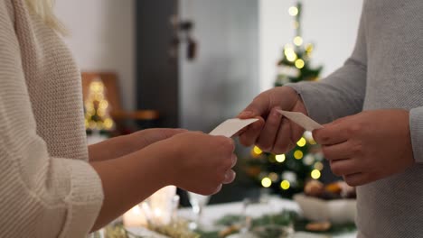 close up of couple make wishes at christmas.