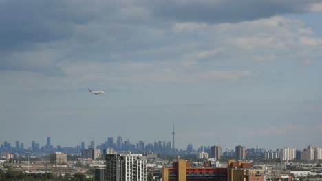 Aerial-view-of-aeroplane-landing-in-a-blue-sky-over-cityscape