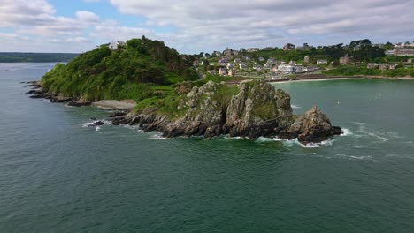 pointe du chateau rocky headland and perros-guirec coastal town, brittany, france. aerial drone backward, copy space