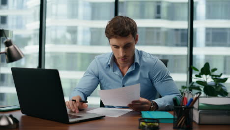 Portrait-surprised-businessman-reading-great-news-in-documents-working-on-laptop