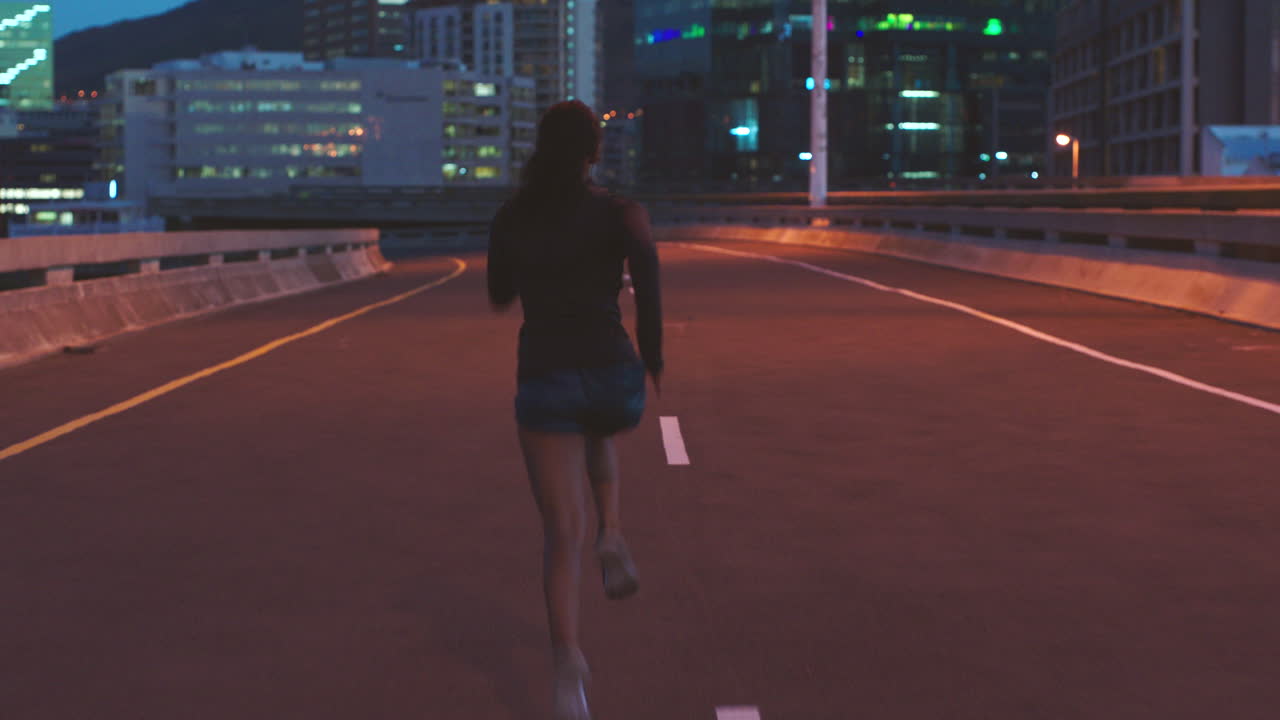 Woman Running at Night in City