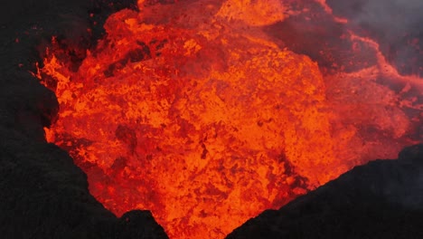 close up aerial view of the volcanic eruption at litli-hrutur, iceland, with lava and smoke coming out