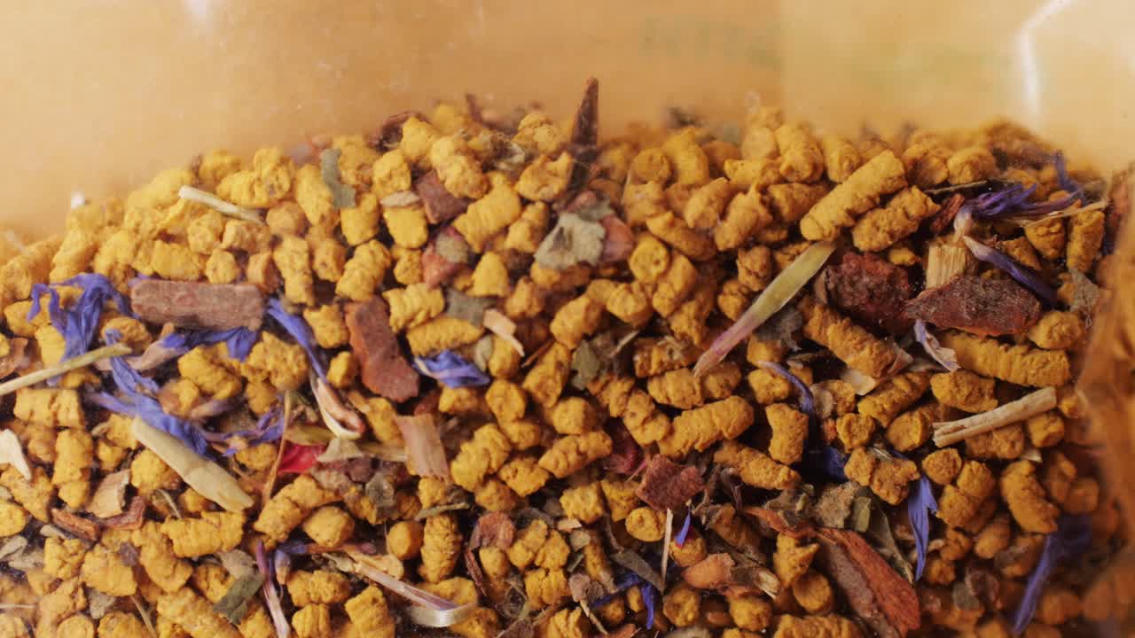 Close-up of a colorful herbal tea blend in a bag