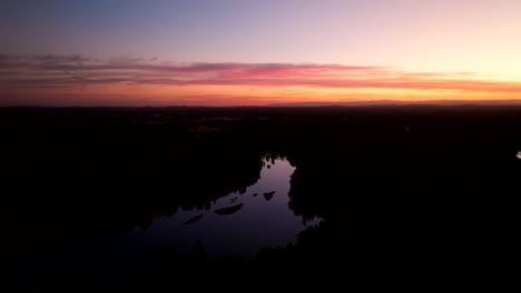 Vibrant blue hour sunset sky reflected in Laja River in Chile, drone view