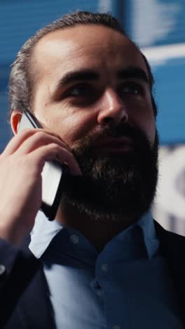 vertical video expert businessman on a smartphone call discussing finance and analytics