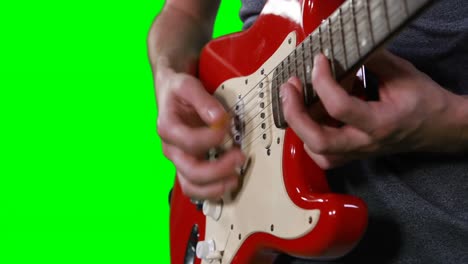 mid section of male musician playing guitar