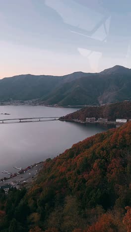 autumn scenery of a japanese lake with mountains and bridge