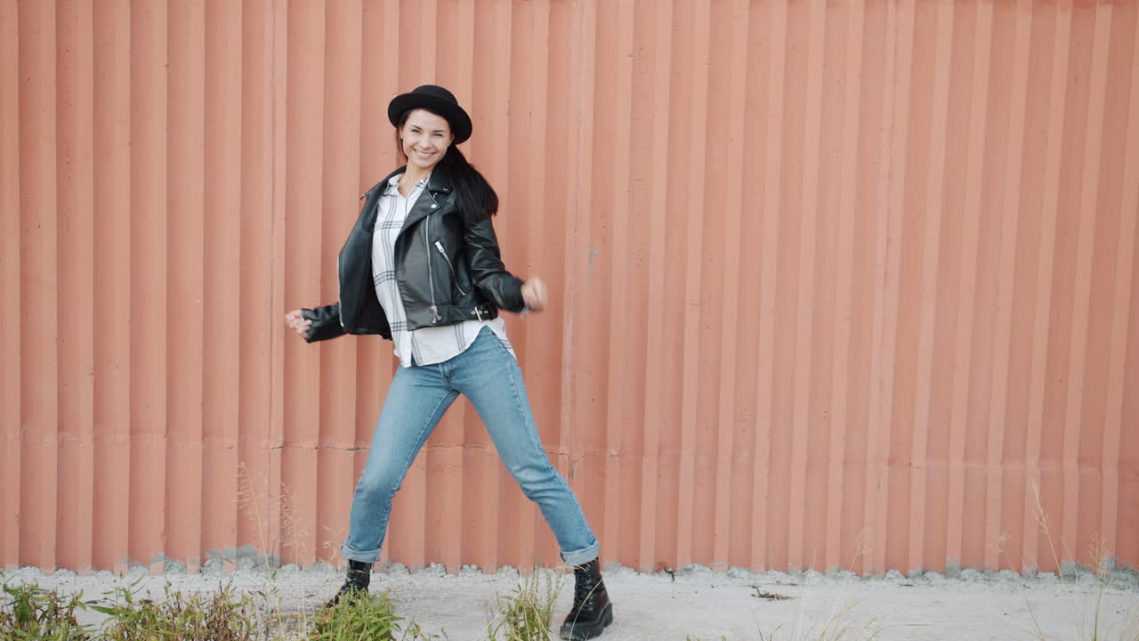 Woman Dancing in Front of Pink Wall