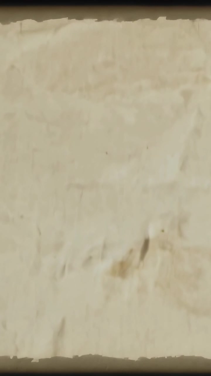Vertical video: Drifting camera showing closeup aged paper creases stains torn edge and dark band