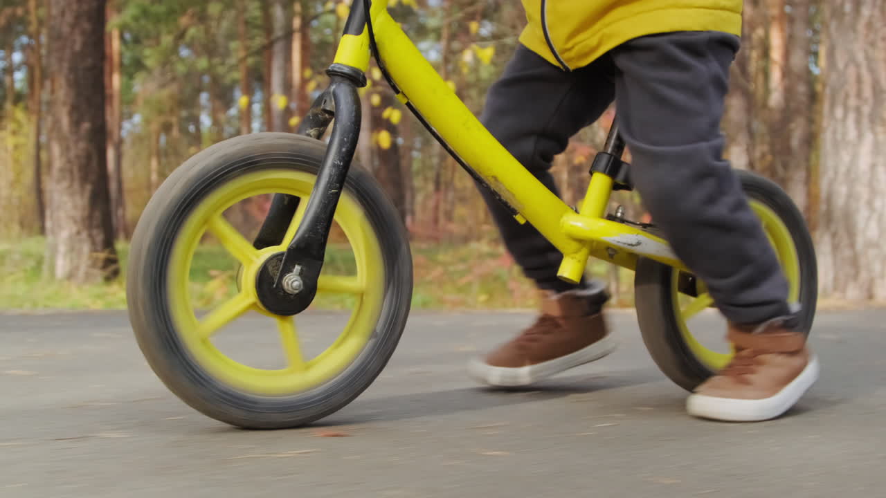Child riding a balance bike in the forest