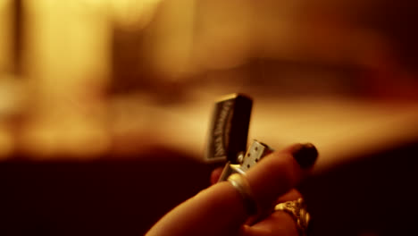 hand holding a lighter in a warm setting