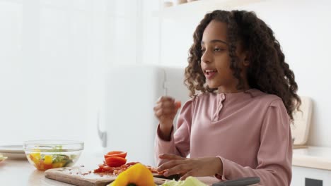 girl learning to prepare a salad