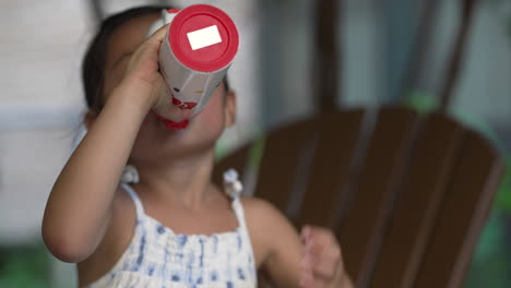 Asian-little-girl-drinking-liquid-water-from-a-water-thermos,-refreshing-concept