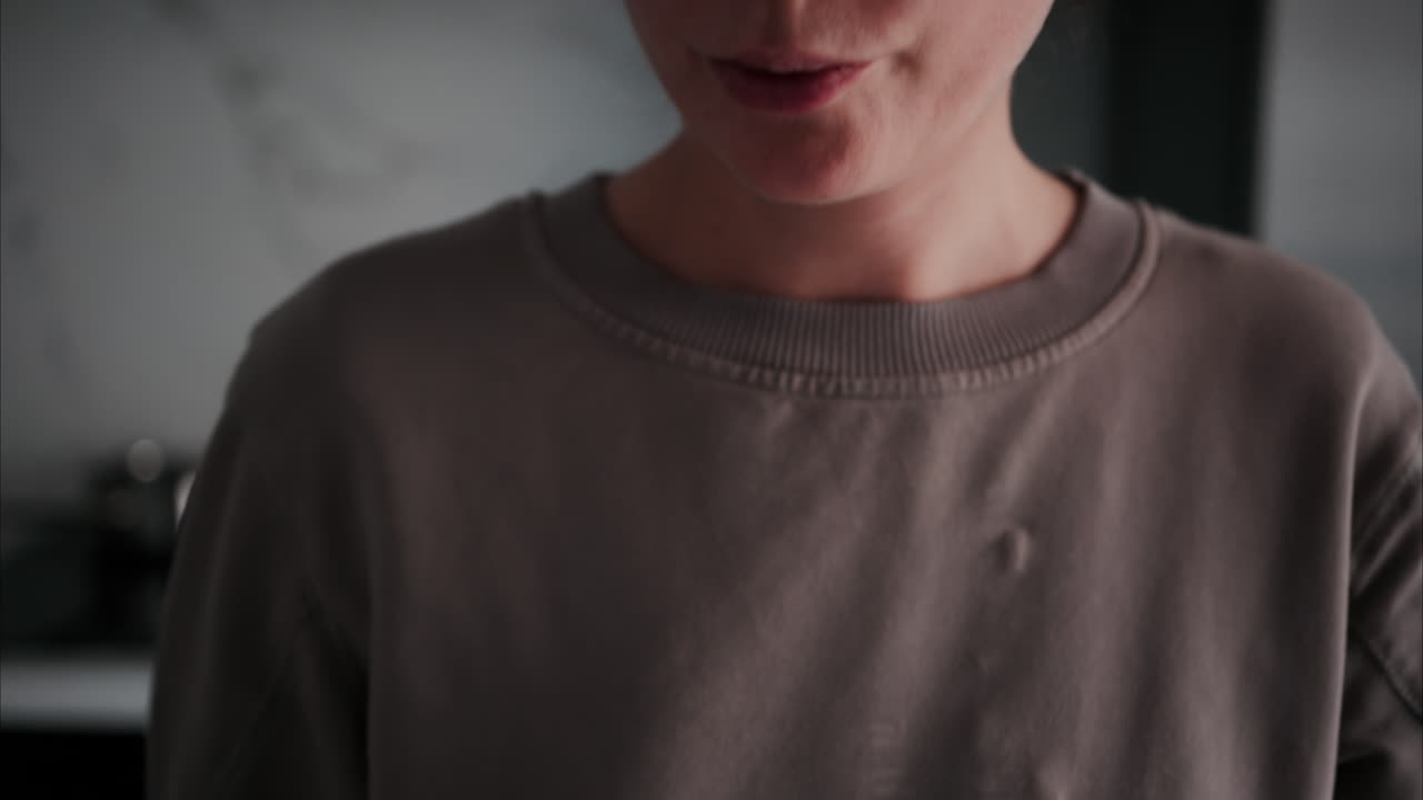 Close up of a woman taking supplements with water at home