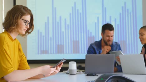 Side-view-of-young-caucasian-female-executive-working-on-digital-tablet-in-modern-office-4k