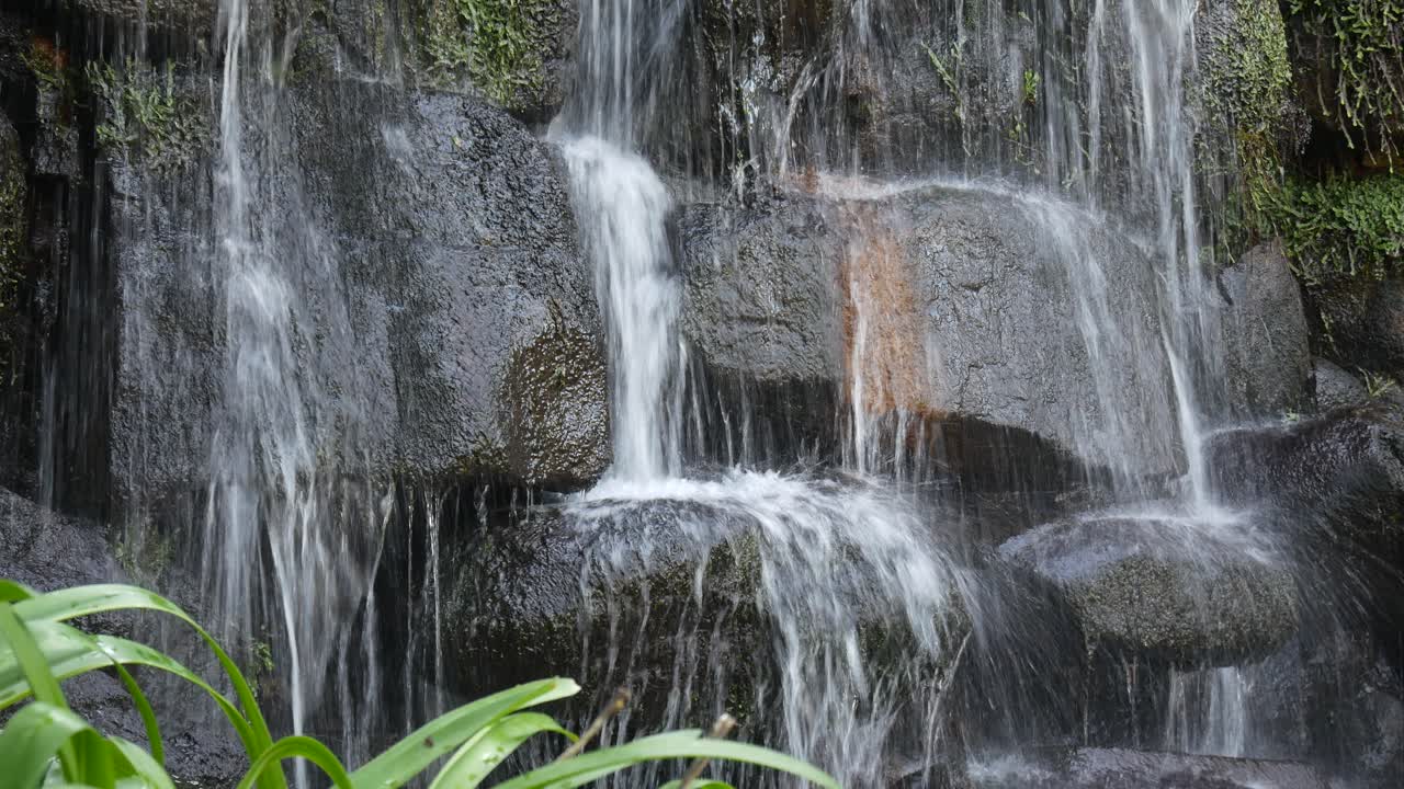Close-up of a Waterfall Cascading Over Dark Rocks