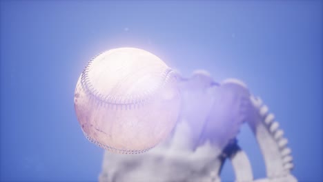 baseball and mitt at blue sky background