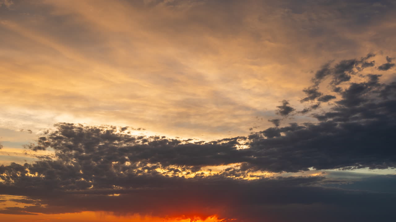 Beautiful sunset sky bright colors in clouds of contrast moving