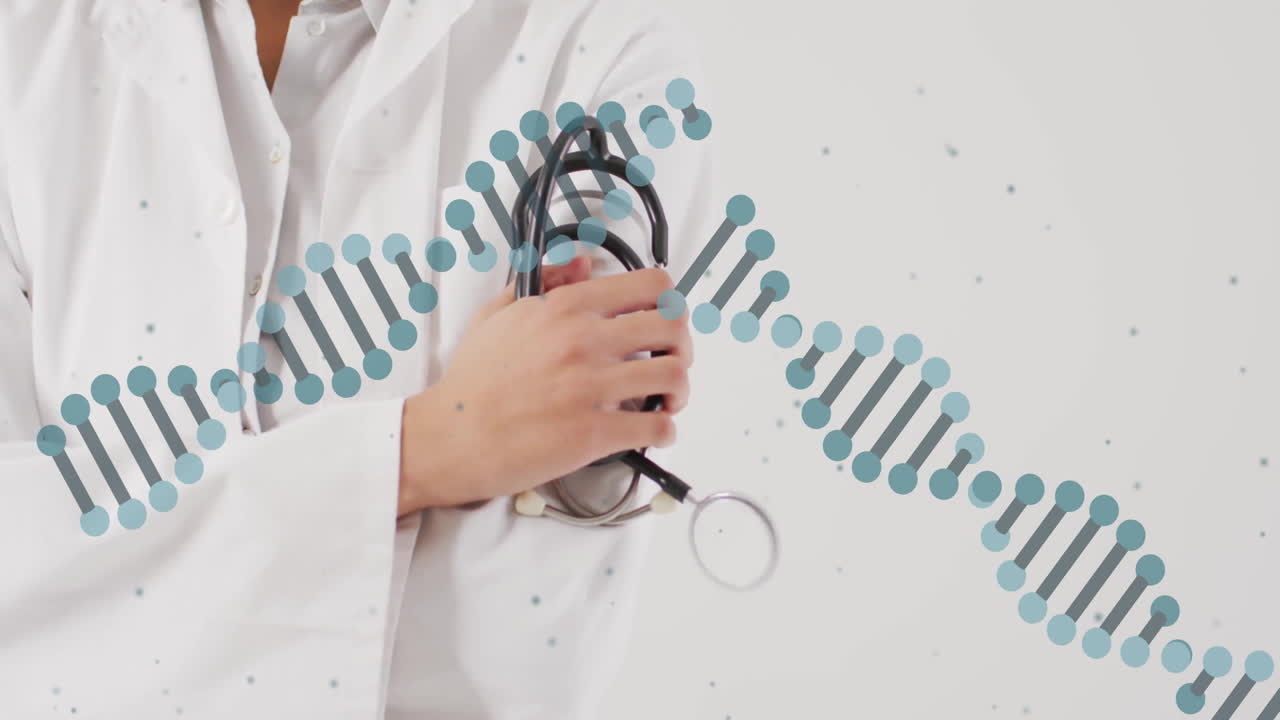 DNA strand animation over person holding stethoscope in medical setting