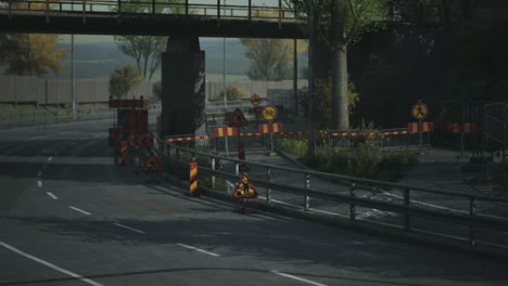 road construction area with warning signs and barriers in a city