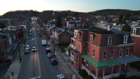 Aerial-view-of-American-city-in-Pennsylvania-with-traffic-on-road-in-the-evening