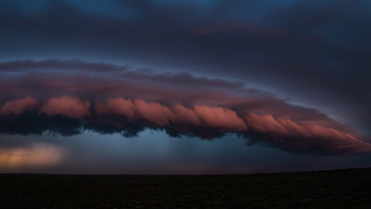 Majestic Storm Cloud Formation Captured at Dusk, Highlighting the Dramatic Color Palette of Nature with Layers of Clouds Creating a Beautiful Atmospheric Scene