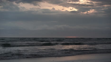 low shot of a sunrise trying to peep out of an overcast and cloudy day at the popular tourist destination burleigh on the gold coast australia