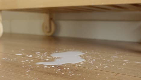 spilled milk on wooden floor