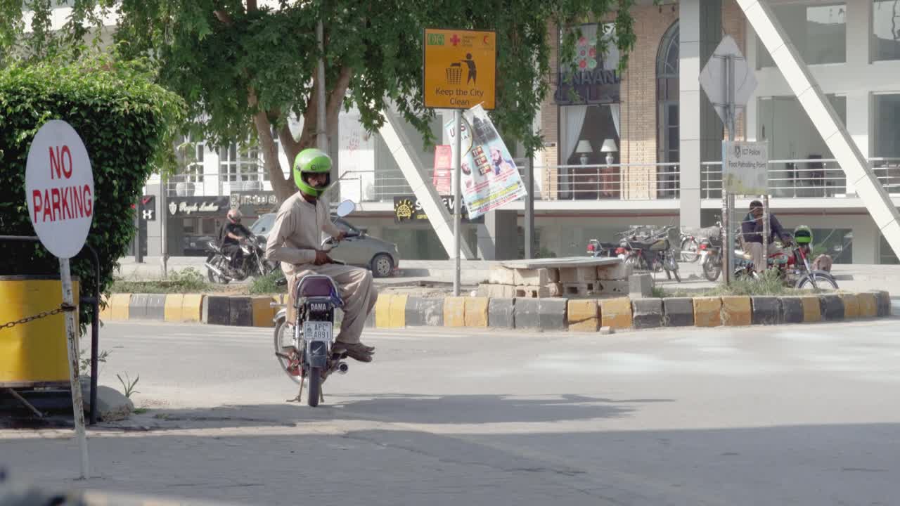 A taxi driver on the street corner is patiently waiting for passengers.