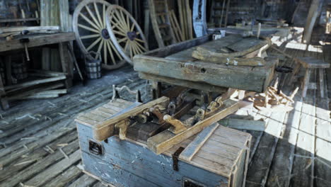 inside a vintage woodworking workshop with tools, wooden boxes and carts