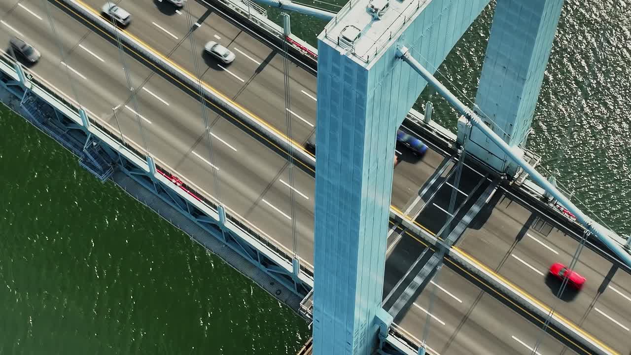 Drone view of traffic on bridge spanning water in New York City