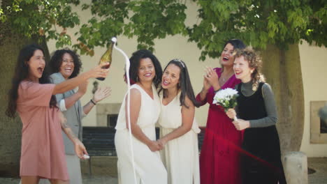 bridesmaid popping champagne at lesbian wedding