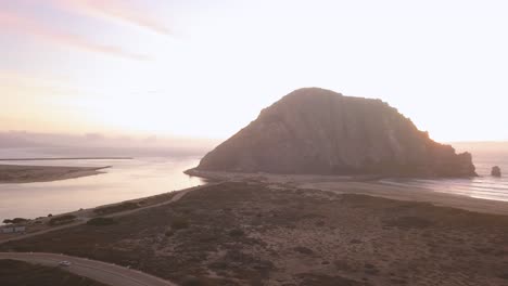 Morro Bay - California, USA. Cinematic right aerial track and rotation along coastline. Filmed at sunset on DJI Mavic Pro