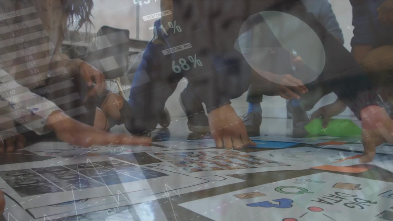 Team placing hands pointing at posters on floor lifting chart percent overlays appearing for design