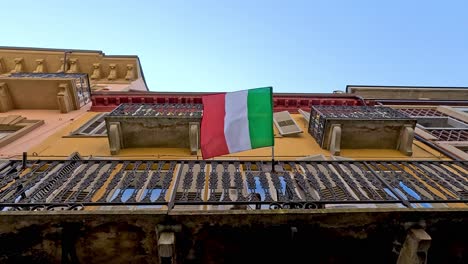 italian flag waving on a balcony in piedmont