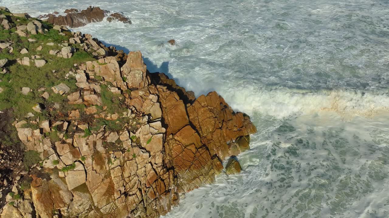 Foamy Sea Waves Breaking On Rocky Cliff In Carballo, A Coru&ntilde;a, Spain - aerial shot