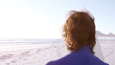surfer standing with surfboard