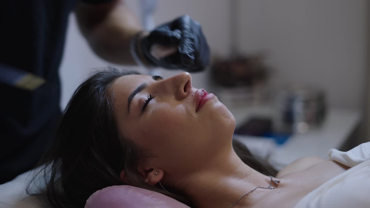 A woman receives a cosmetic nose injection during a non-surgical procedure