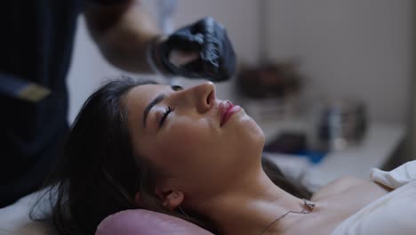 a woman receives a cosmetic nose injection during a non-surgical procedure