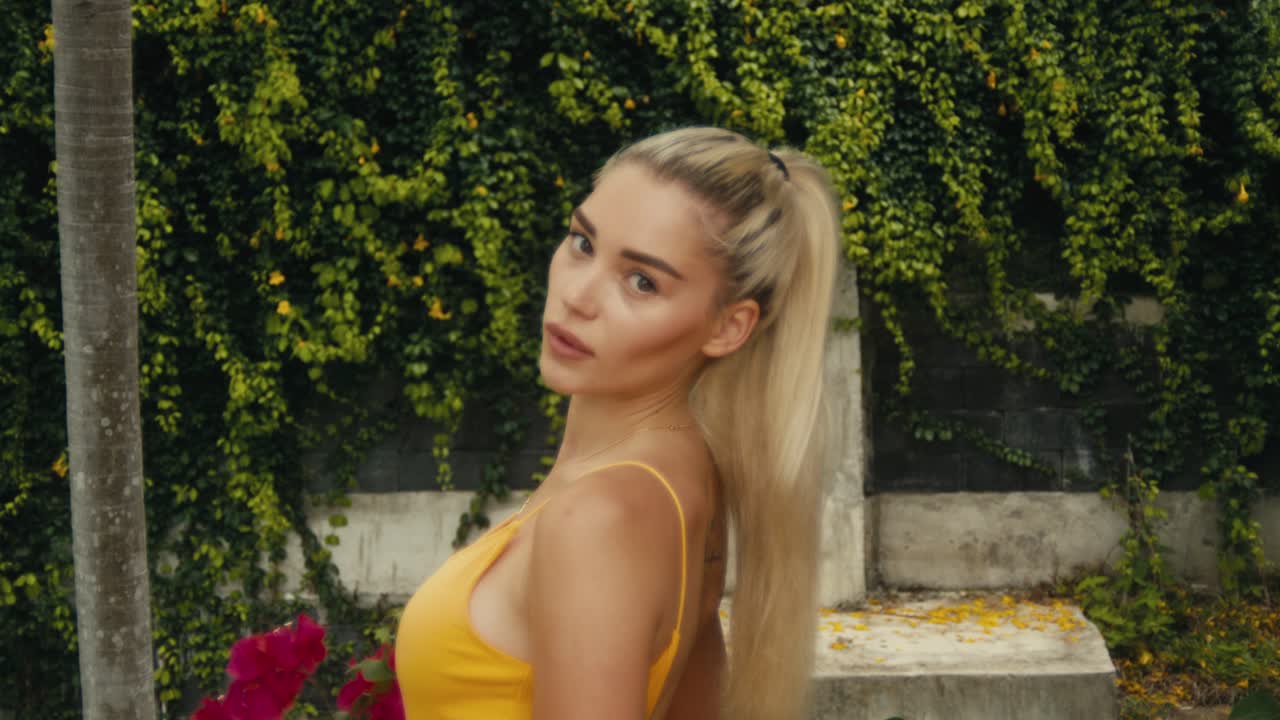 Woman in a yellow dress holding flowers