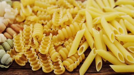 Various-pasta-in-different-colour-on-wooden-table