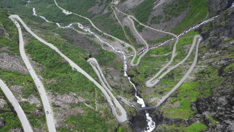 trollstigen mountain pass, norway - scenic route with hairpin turns in romsdalen valley - aerial tilting down