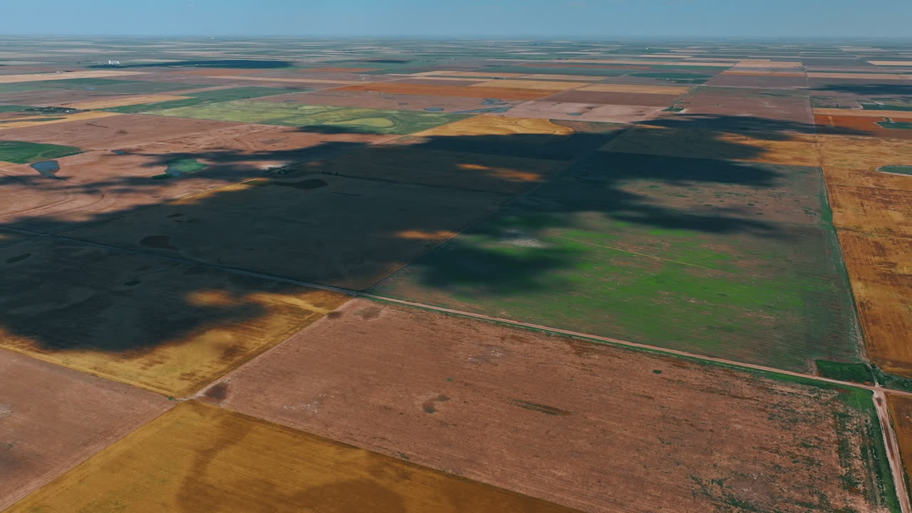 Huge plain territory divided on rectangular areas. Vast dry farmlands from aerial perspective.