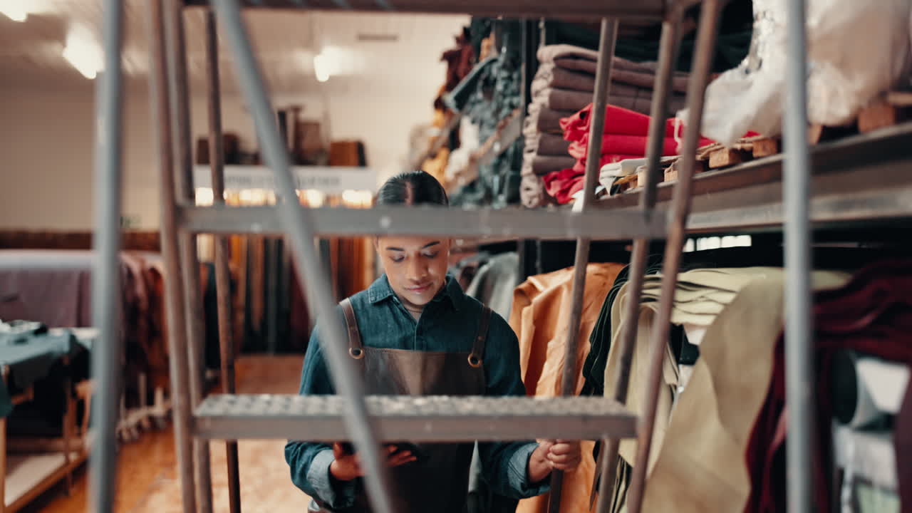 Tablet, leather workshop and woman on ladder
